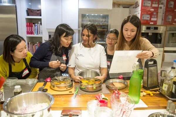 Chef Teena leading a corporate team cooking class